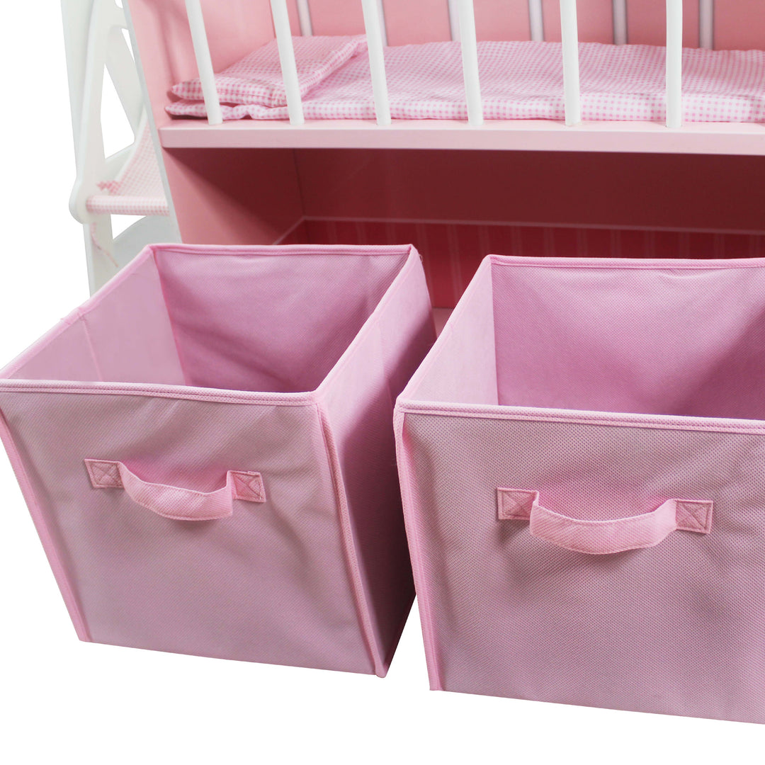 A close-up of the two pink cubby containers that fit in the shelf beneath the crib in pink.