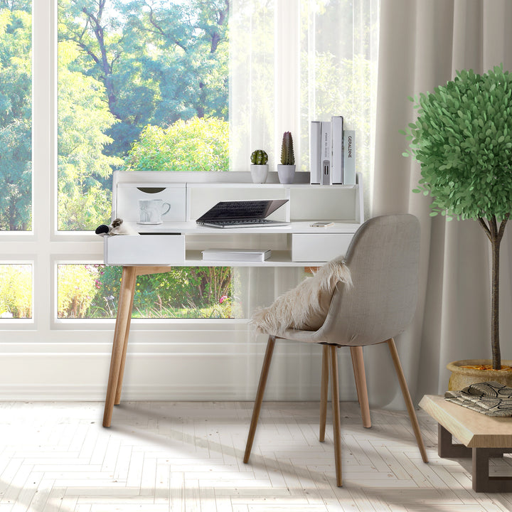 A durable Teamson Home Creativo Wooden Writing Desk with Storage in white with a chair in front of a window.