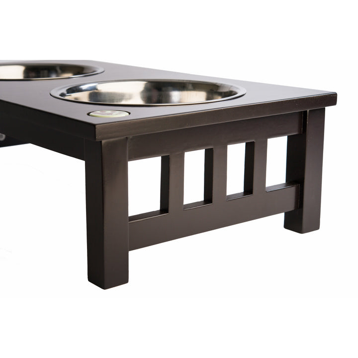 A view of a raised pet feeder with two stainless steel bowls.