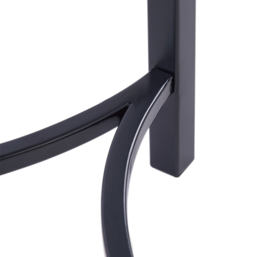 A close-up of the metal chair legs on the Teamson Home Shenna Floor Lamp with Faux White Marble Tray Table, Black