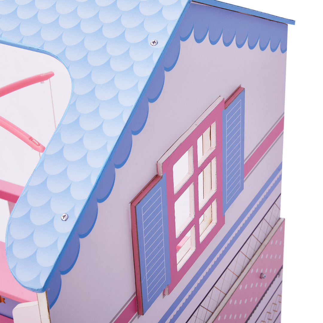 A close-up of the detailed shingles and window in periwinkle and pink.
