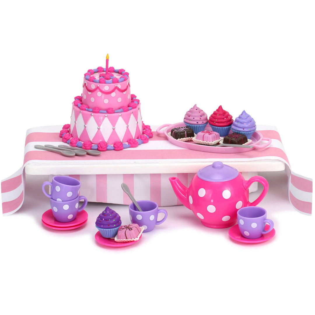 Includes: a birthday cake, 4 pink and purple cupcakes, 4 brown and pink petit fours, 4 purple tea cups with white polka dots, a pink teapot with white polka dots, 4 pink saucers, 4 silver spoons, pink tray and striped napkins.