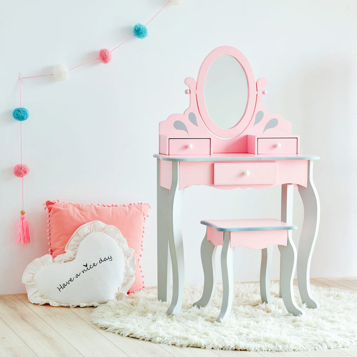 A child's vanity table with a matching stool and an oval mirror in pink and gray.