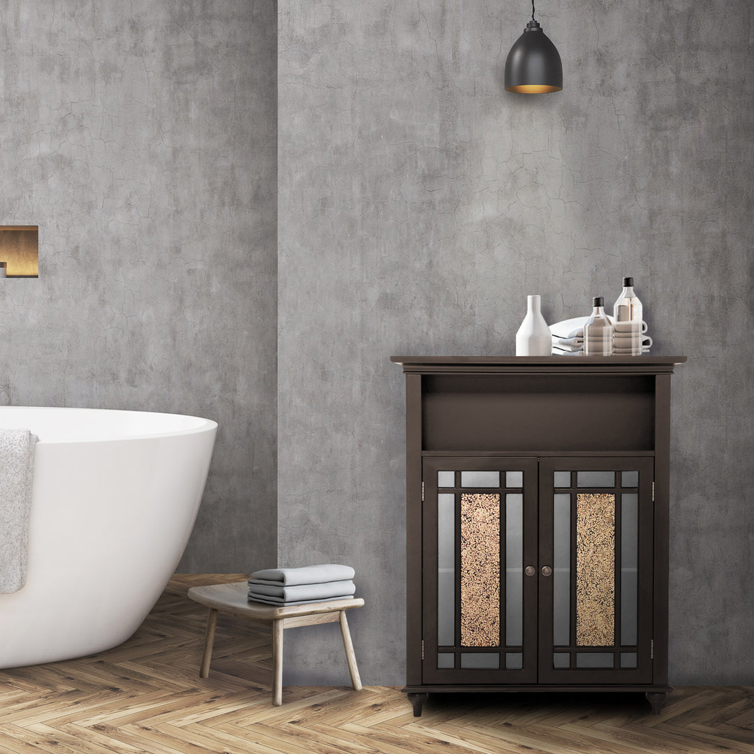 A dark expresso Teamson Home Windsor Floor Cabinet with Glass Mosaic Doors in a gray bathroom underneath a pendant light next to a white bathtub