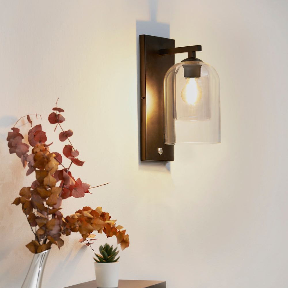 Teamson Home Matte Black Wall Sconce with Double Glass Shade from the side, illuminated