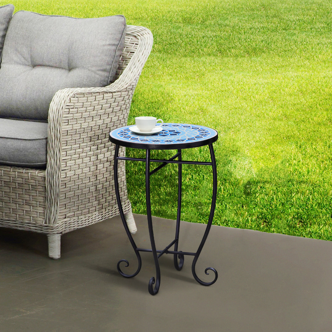 Teamson Home Small 14" Round Outdoor Mosaic Side Table Planter Stand, Blue, next to a PE rattan loveseat outdoors