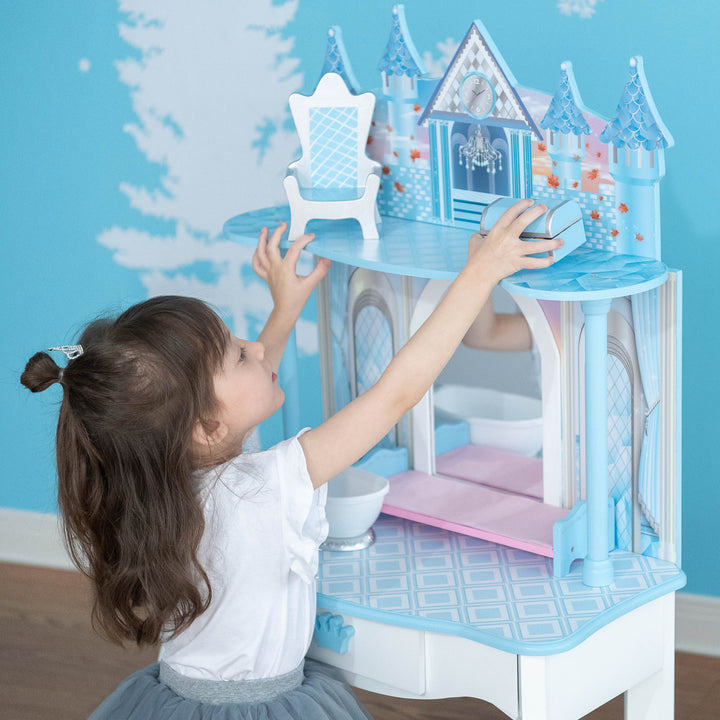 A little girl playing with a Fantasy Fields Kids Dreamland Castle Vanity Set with Chair and Accessories, White/Blue toy.