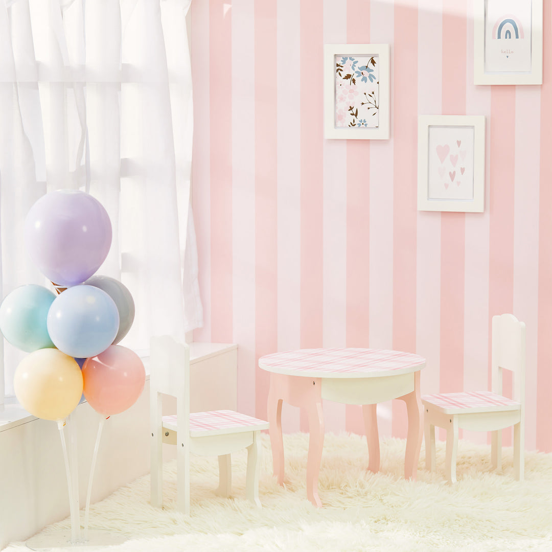 A pink and white striped room with balloons, dolls, and a Sophia's by Teamson Kids Aurora Princess Table & Chairs set.