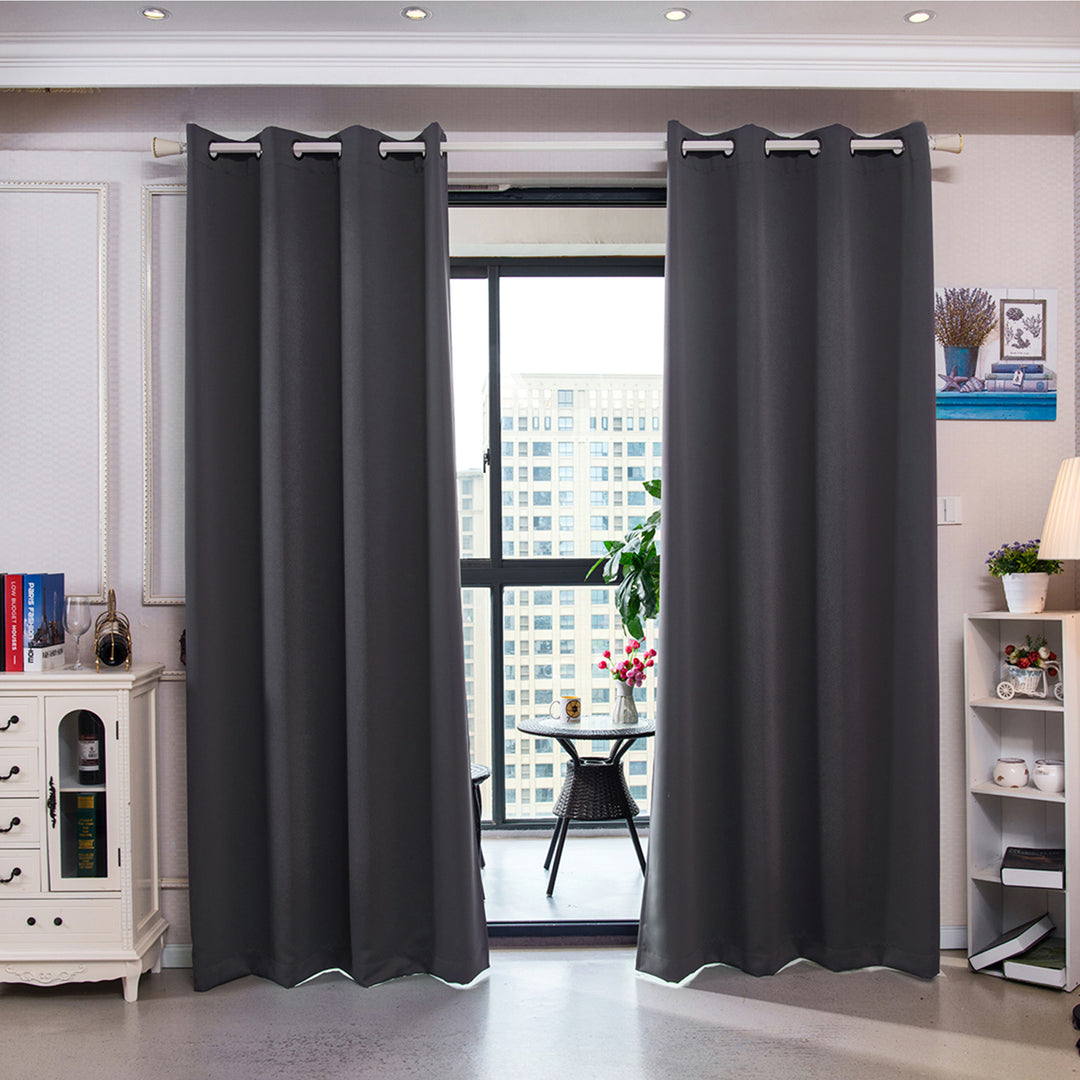 Modern living room with Teamson Home 63" Sparta Insulated Thermal Blackout Window Curtain Panels with Grommets, Dove Gray drawn closed over a large window.