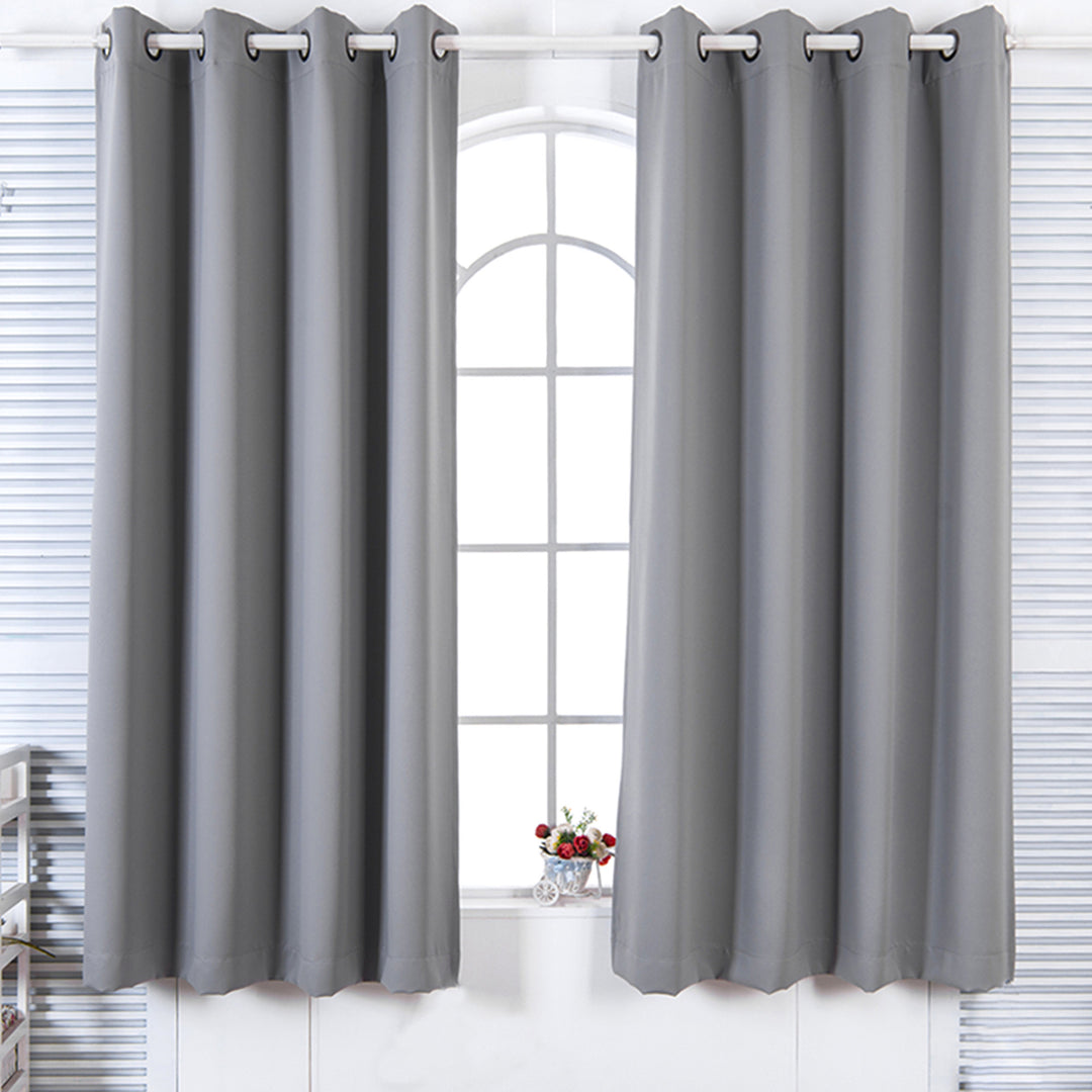Teamson Home 63" Lamia Premium Solid Insulated Thermal Blackout Window Curtain Panels with Grommets, Fossil Gray hanging in front of a window panel with a vase of flowers on the windowsill.