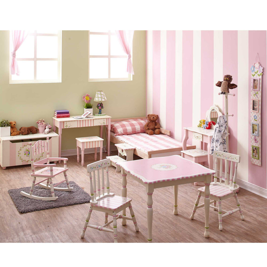 A pink and white children's room with TEAMSON KIDS furniture and a Fantasy Fields Kids Furniture Play Vanity Table and Stool, Pink/White rocking chair.
