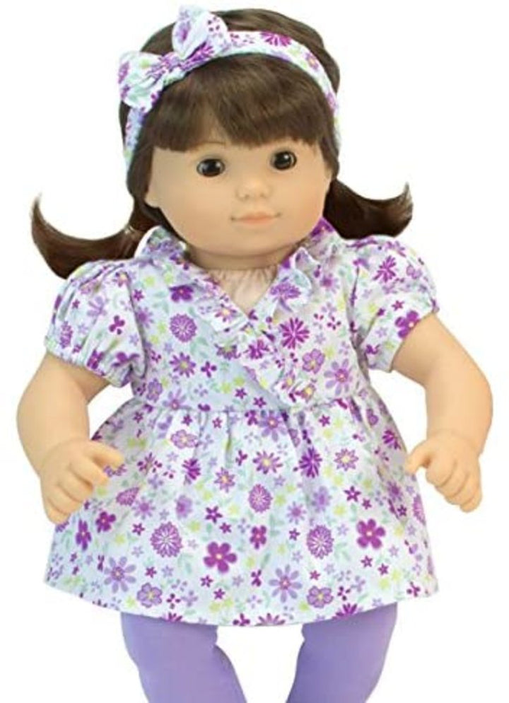 A 15" Doll with dark hair and eyes dress in a white with purple floral print top and matching headband and purple leggings.