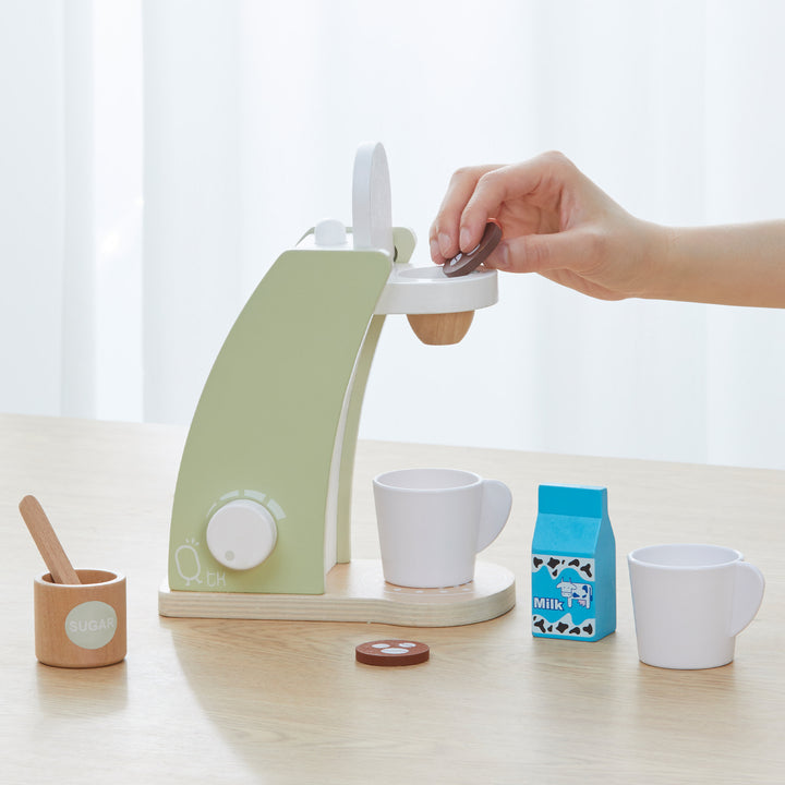 someone adds the coffee pod to the top of the Little Chef Frankfurt Wooden Coffee maker