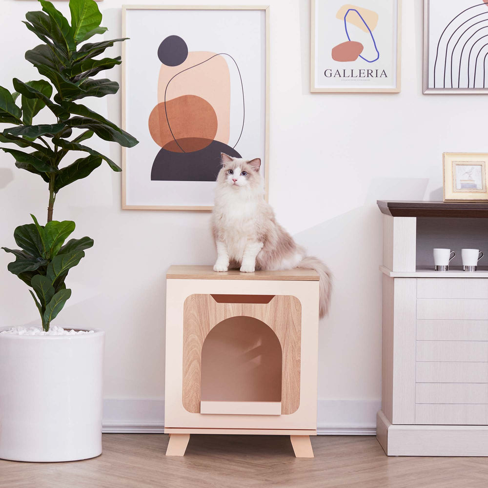 A white cat sitting on top of a Teamson Pets Elyse Elevated Vented Wooden Cat Litter Box Enclosure Side Table, Tan and White