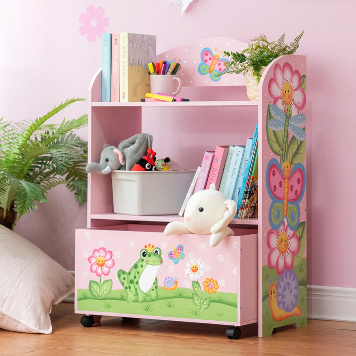 A pink bookcase with a stuffed animal and a Fantasy Fields Magic Garden Kids Wooden Toy Organizer with Rolling Storage Box, Pink.