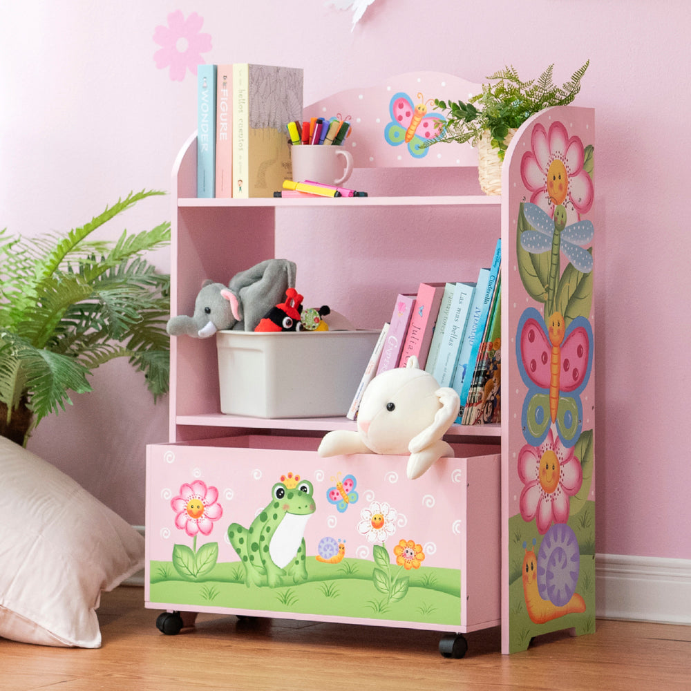 A pink bookcase with a stuffed animal and a Fantasy Fields Magic Garden Kids Wooden Toy Organizer with Rolling Storage Box, Pink.