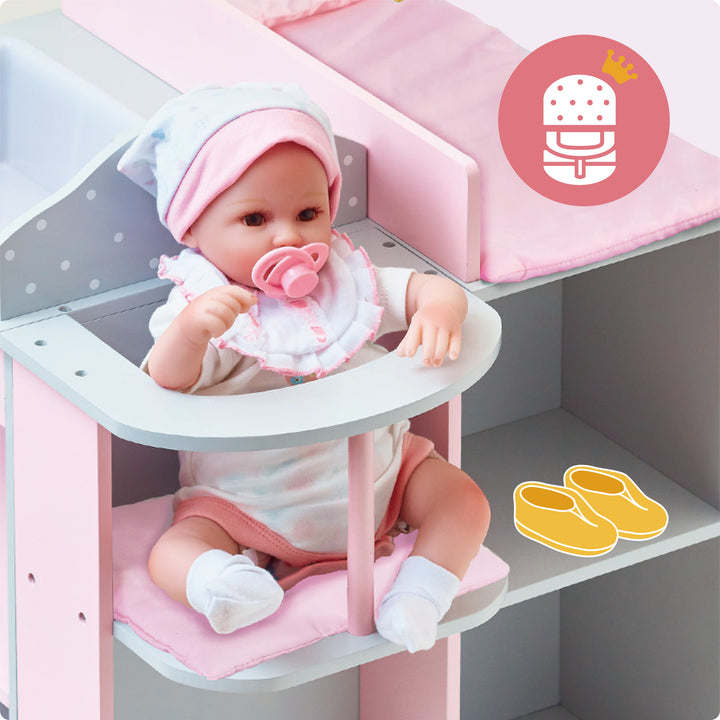 Olivia's Little World Kids Polka Dots Princess Baby Doll sitting in a pink high chair with a pacifier.