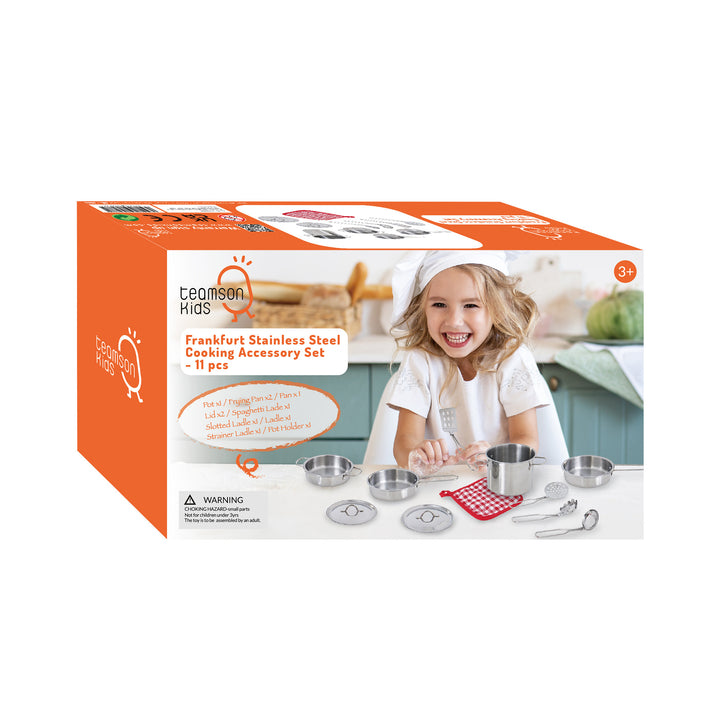 A Teamson Kids 11 Piece Little Chef Frankfurt Stainless Steel Cooking Accessory Set packaging image featuring a smiling child on the box.