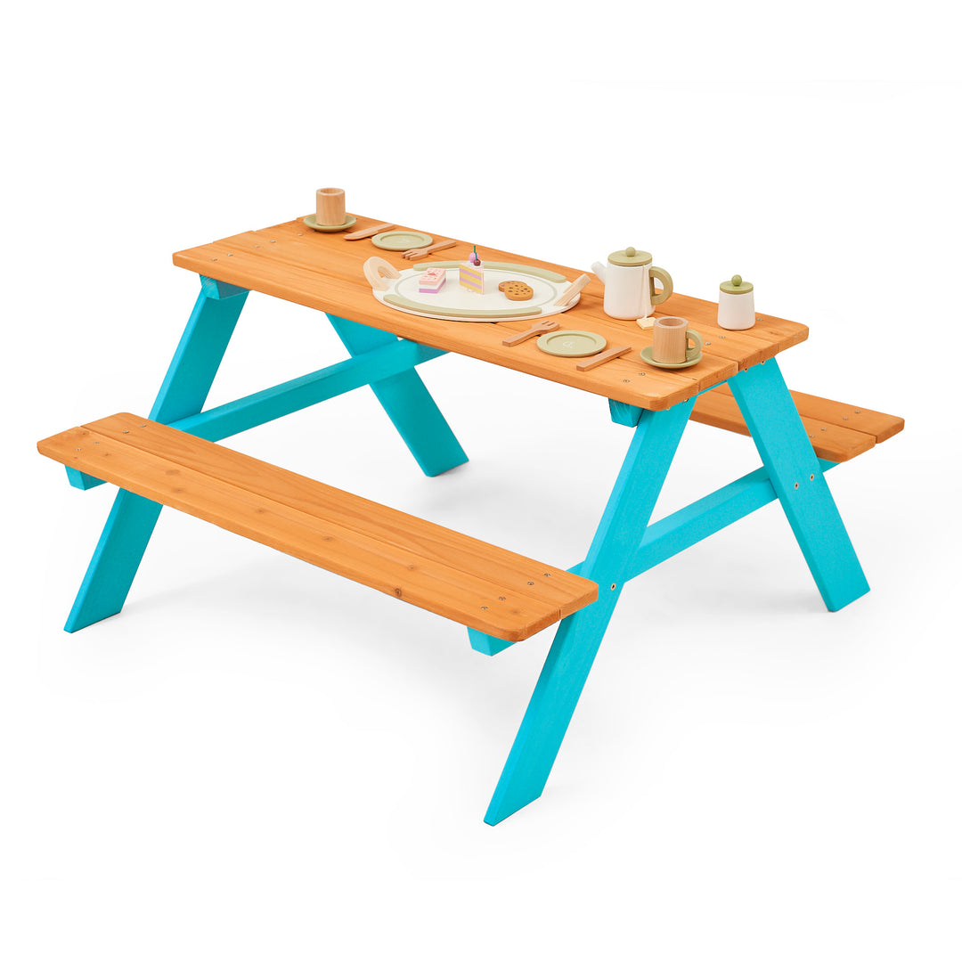 Teamson Kids Child Sized Wooden Outdoor Picnic Table, Warm Honey/Aqua with play food set in various colors on a white background.