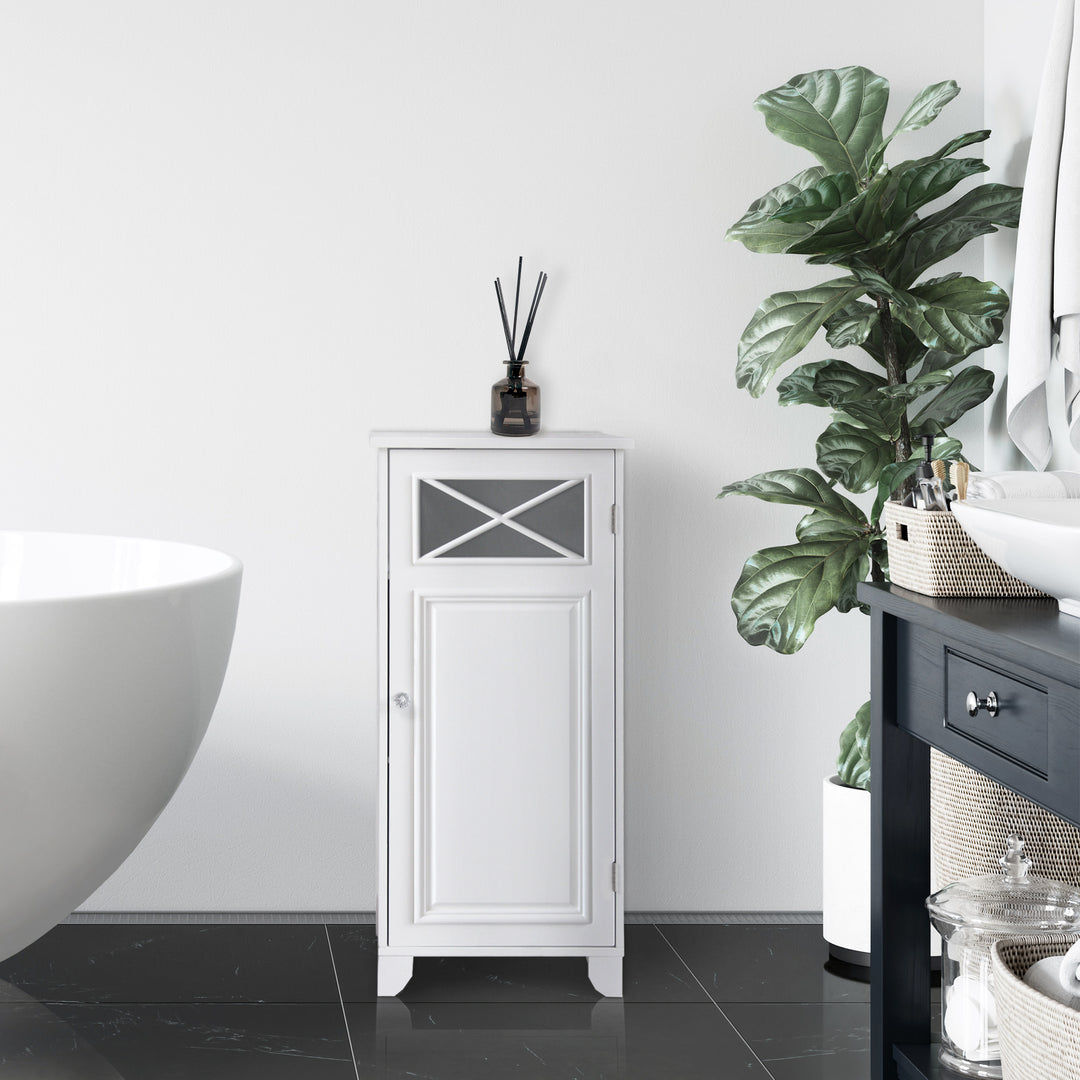 The Teamson Home Dawson Floor Cabinet, White, in a bathroom between a bathtub and potted plant