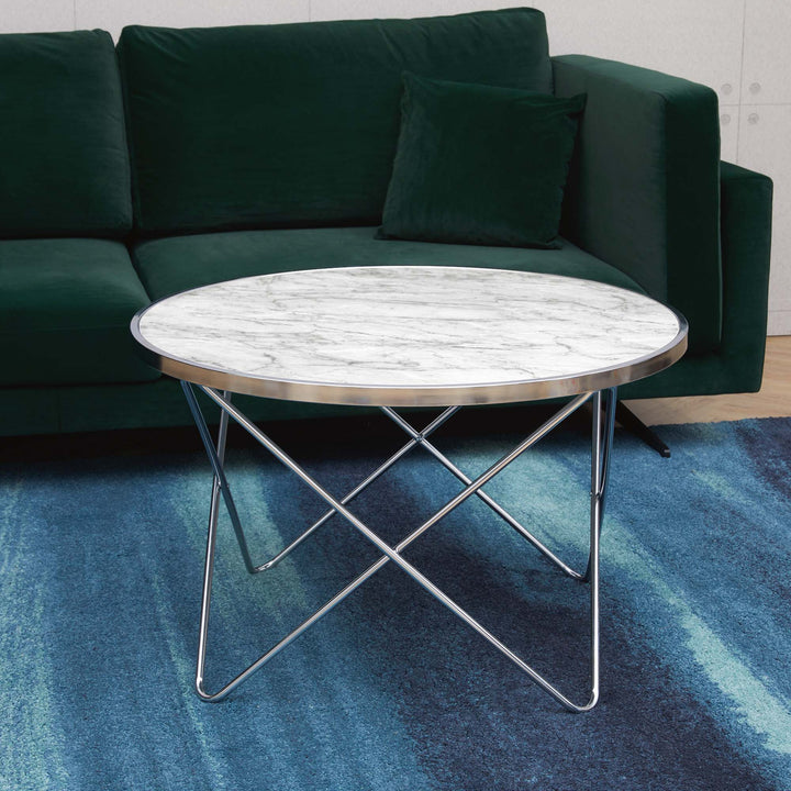 Teamson Home Margo Small Round Faux White Carrara Marble coffee table with chrome legs on a blue rug.