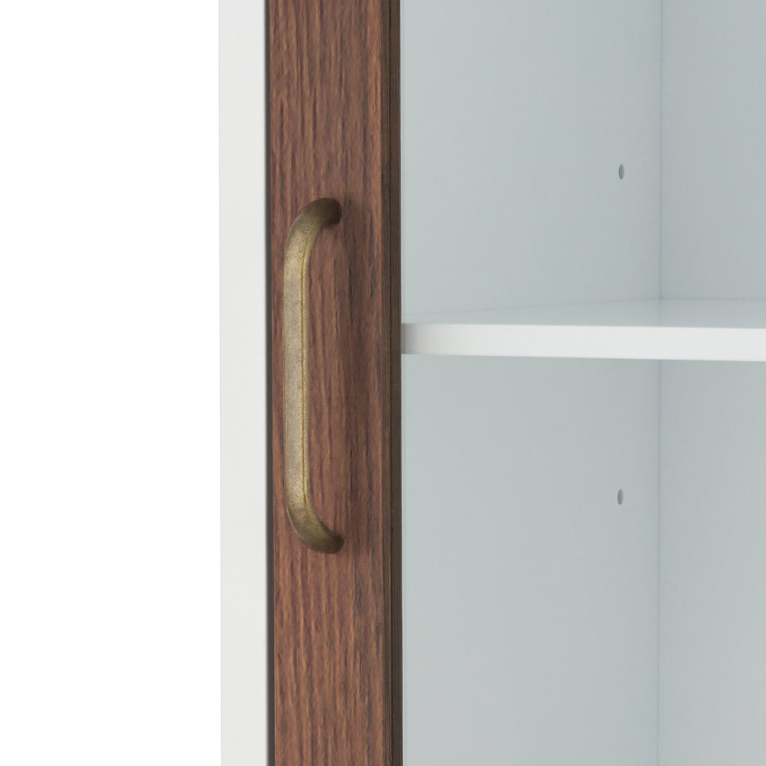Close-up of the brass pull handle on the Teamson Home Tyler Modern Linen Storage Cabinet with Two Doors, Walnut/White