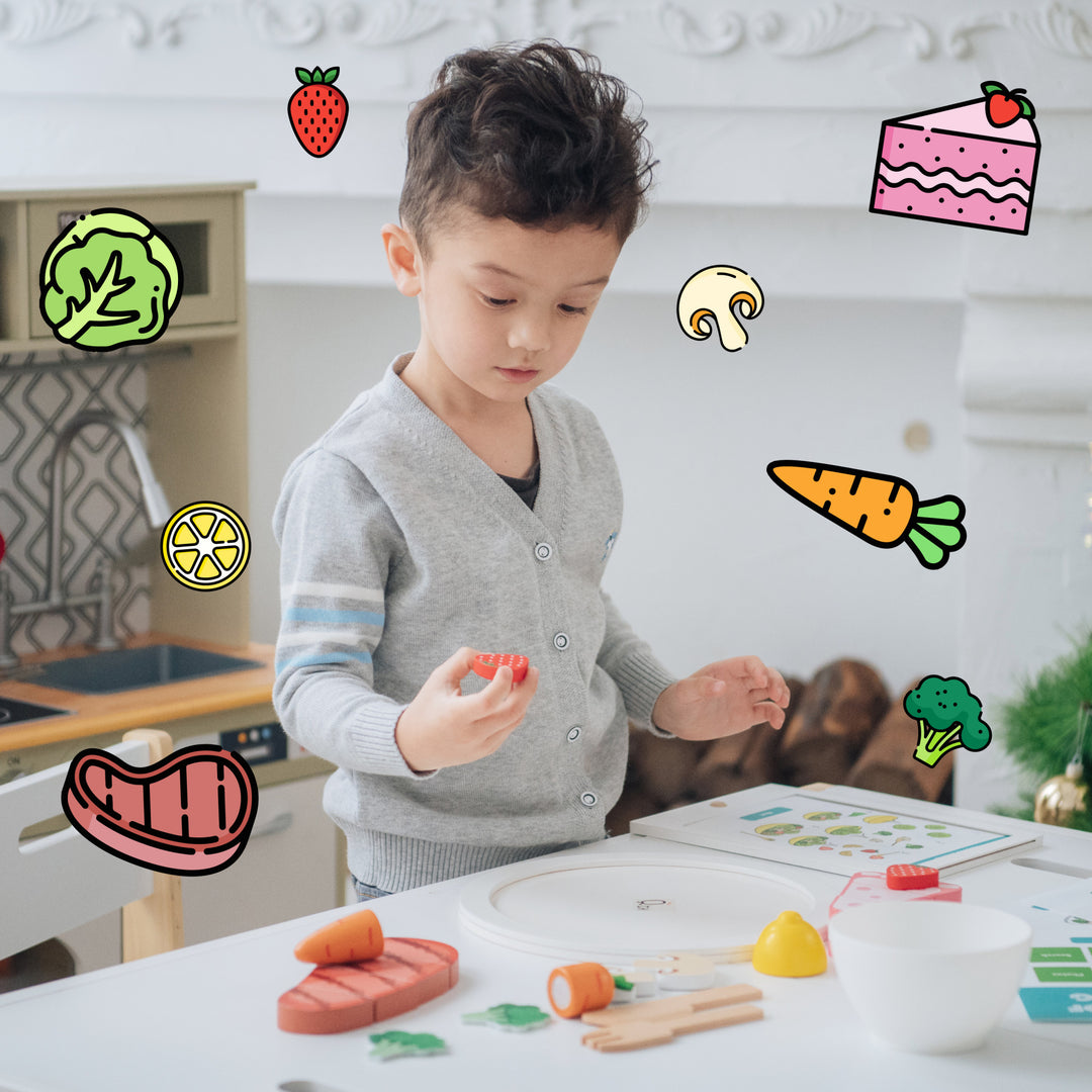 A young child engaged in a play-based learning activity with pretend ingredients and illustrations in the Teamson Kids Little Chef Frankfurt 27 Piece Wooden Play Cooking Set with Recipe Tablet and Ingredients.