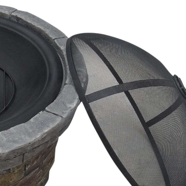 A black wireless speaker next to a Teamson Home 27" Outdoor Round Stone Wood Burning Fire Pit with Steel Base, Natural Stone on a light background, featuring an outdoor decor steel base.