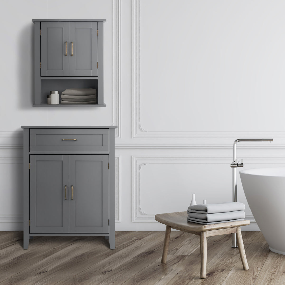 Mercer gray floor cabinet below a coordinating wall cabinet in a white bathroom next to a tub and stool