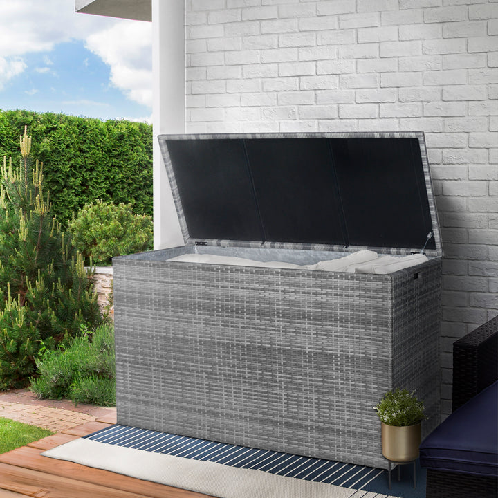 Teamson Home Gray PE Rattan 154-Gallon Outdoor Deck Box with the lid open and cushions inside