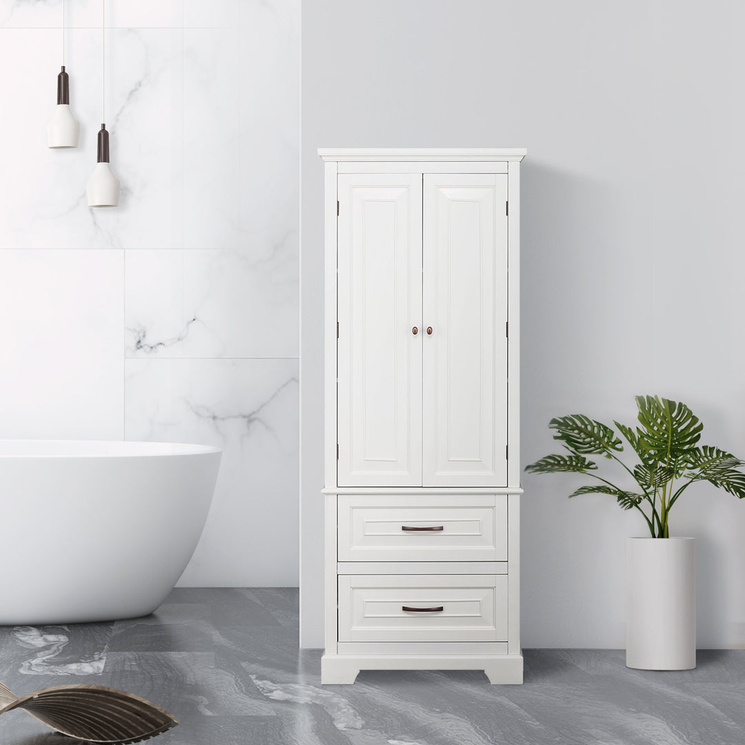 White Teamson Home St. James wooden linen tower cabinet next to a freestanding bathtub with a potted plant in a modern bathroom setting.