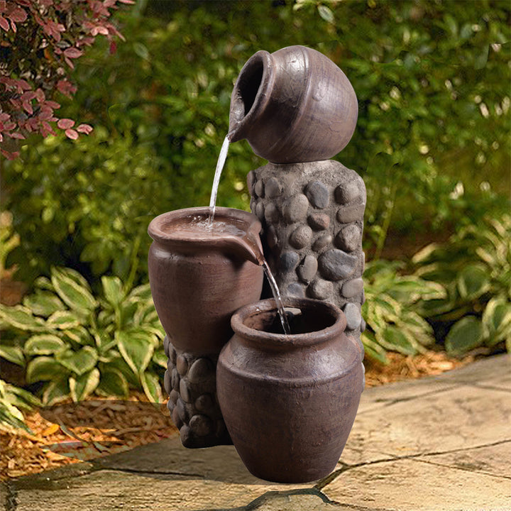 Teamson Home Outdoor Cascading Stacked Pot Water Fountain in a landscaped setting