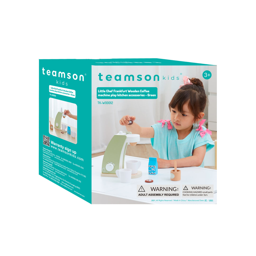 A young child playing with a Teamson Kids Little Chef Frankfurt 8 Piece Wooden Play Kitchen Coffee Machine Set, including pretend accessories and a coffee maker set, in green, depicted on the product's packaging.