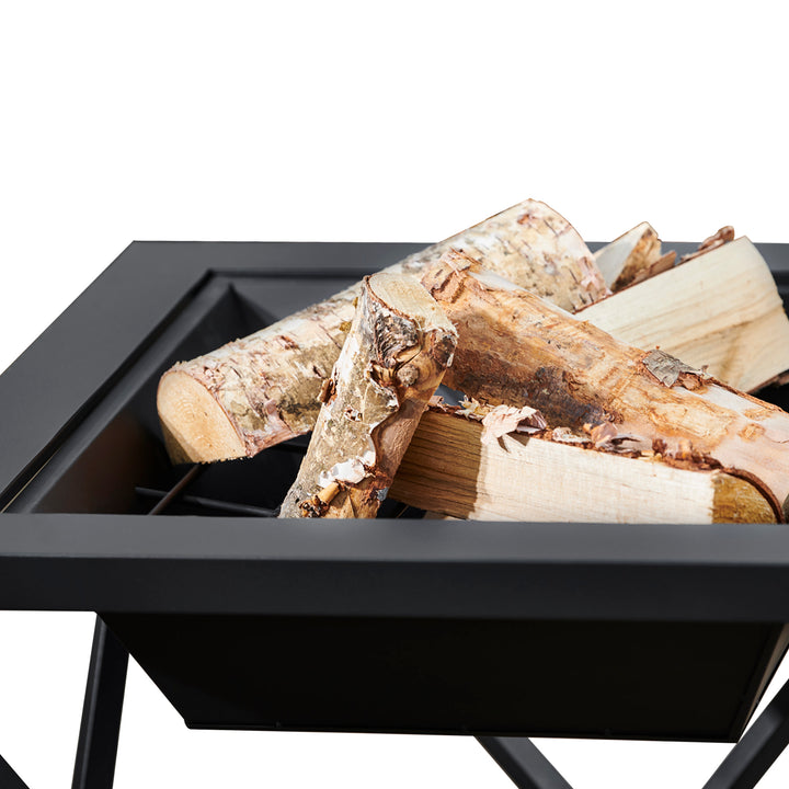 A stack of wood inside the Teamson Home Outdoor 24" Wood Burning Fire Pit with Tabletop and Decorative Base, Black