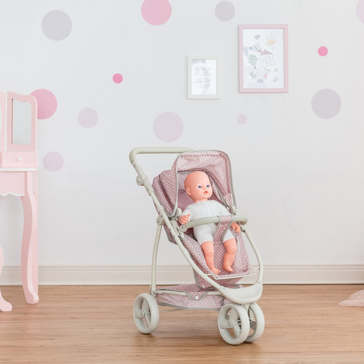 A baby doll seated in the pink with gray polka dots convertible baby doll stroller.