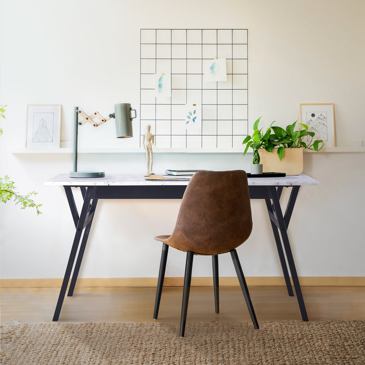 Teamson Home Ashton Dining Table with Black Wood Base and Faux Marble Tabletop with a brown chair, industrial table lamp, and a planter