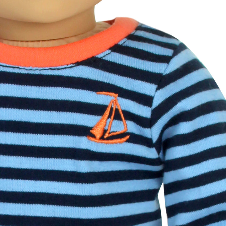 A close-up of an embroidered orange sailboat on a navy and light blue striped pajama top for 18" dolls.