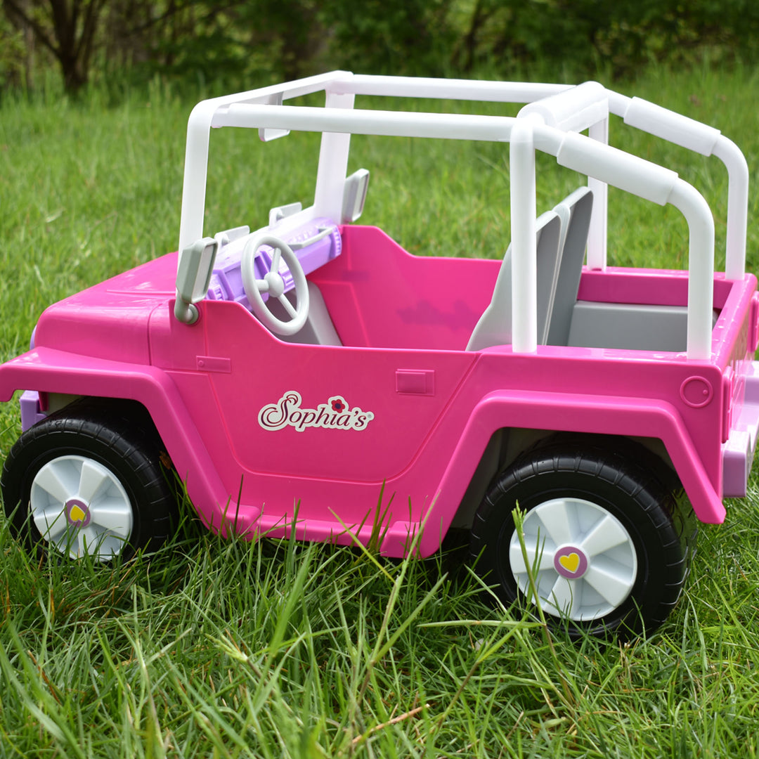 Sophia's 4 x 4 Hot Pink Beach Cruiser Truck for 18" Dolls is parked in the grass.