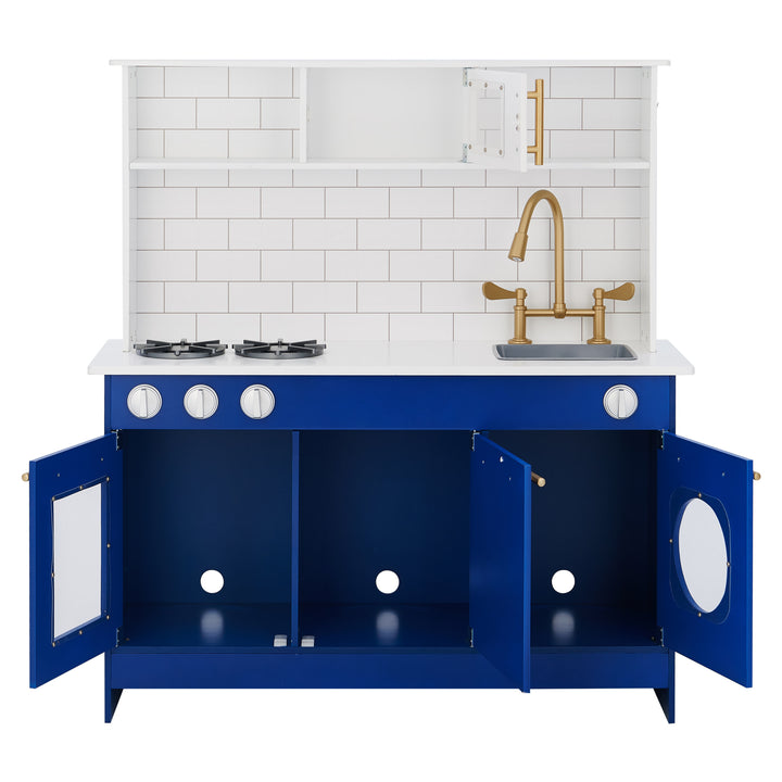 Modern blue Teamson Kids Little Chef Berlin Play Kitchen with Cookware Accessories, White/Blue playset with white countertop, two burners, and brass fixtures against a white subway tile backsplash from Teamson Kids.
