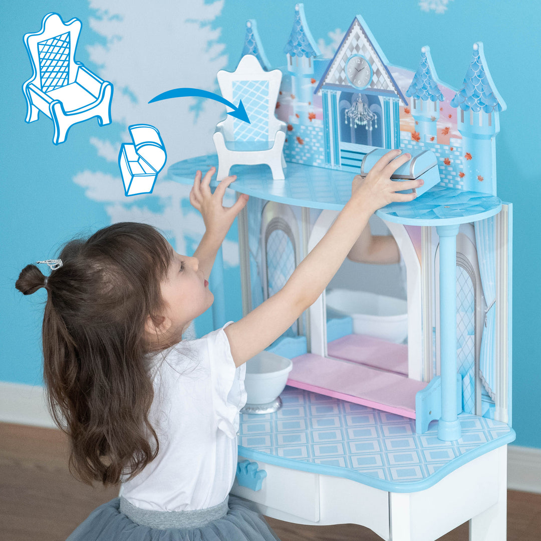 A little girl is playing with a Fantasy Fields Kids Dreamland Castle Vanity Set with Chair and Accessories, White/Blue toy.