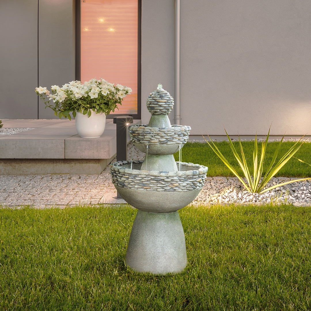 Teamson Home Outdoor 3-Tier Pedestal Floor Fountain, Gray, outside a modern home next to a pebble path with plants