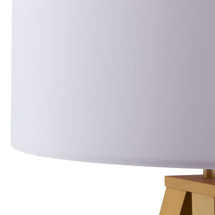 Close-up of a Teamson Home Romanza 62" Postmodern Tripod Floor Lamp with Drum Shade, Matte Gold/White on a white background.
