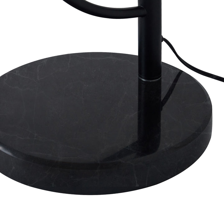 A close-up of the black faux marble base