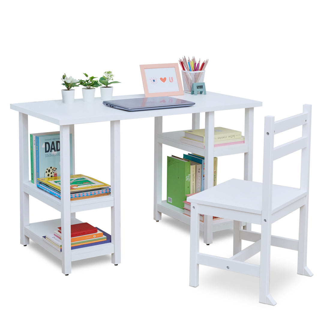 A white children's desk and matching chair with supplies on the top of the desk and books on the shelves below.