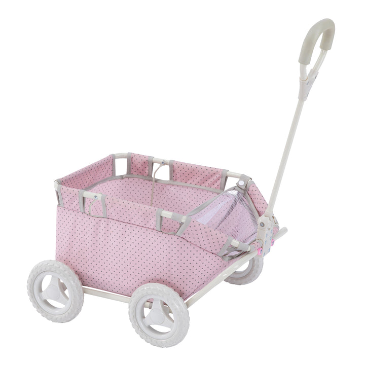 A baby doll wagon pink with gray polka dots, white frame and wheels, with the handle in the upright position.