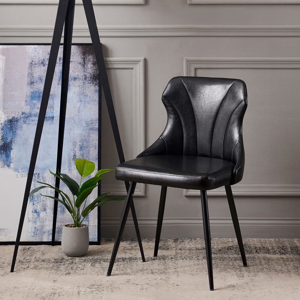 Teamson Home Finley Dining Chair with Faux Black Leather  in front of a painting.