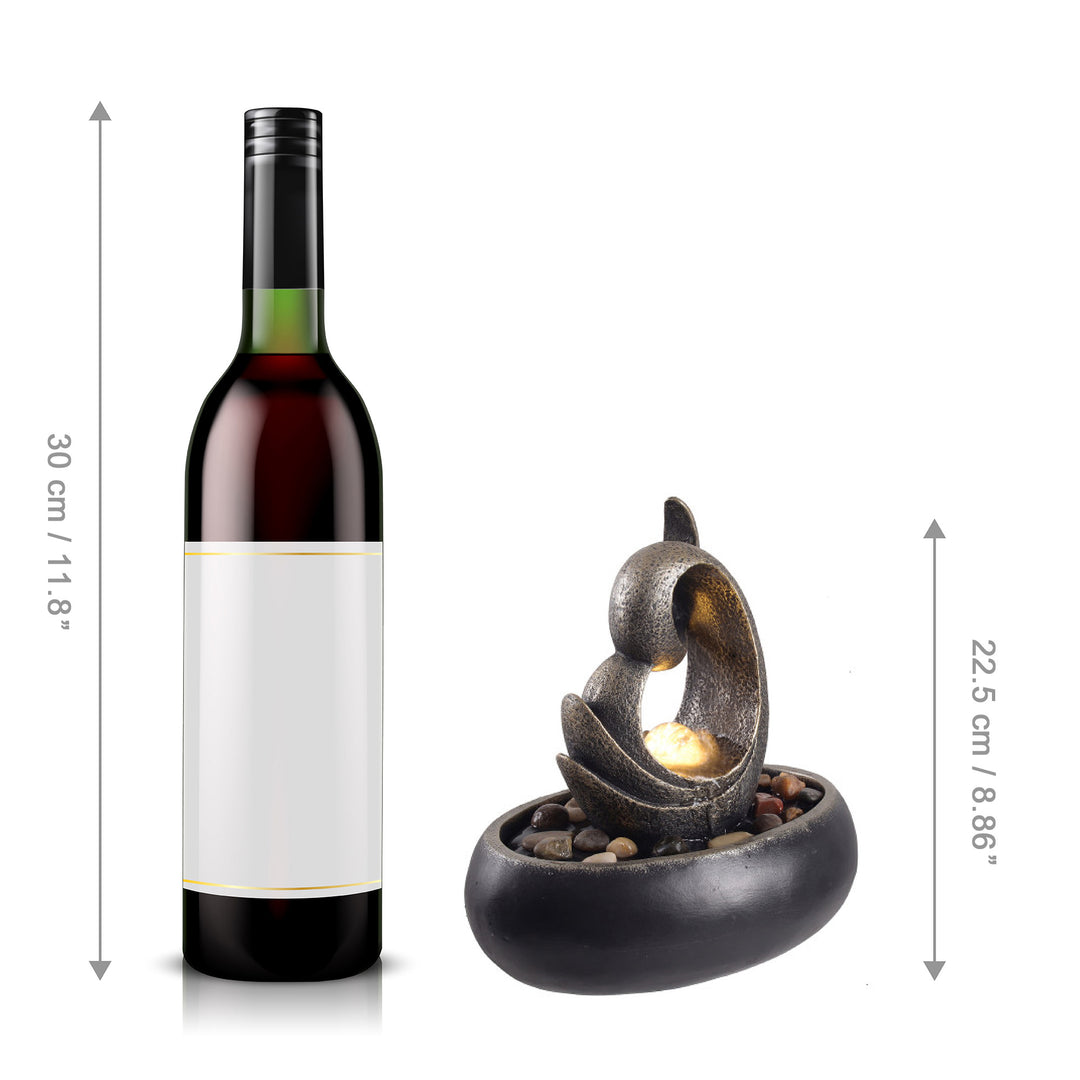 A Teamson Home Tabletop Water Fountain with LED light, Bronze next to a bottle of wine, fitted with LED lights and measurements indicated for both items, highlights its suitability as indoor/outdoor decor.
