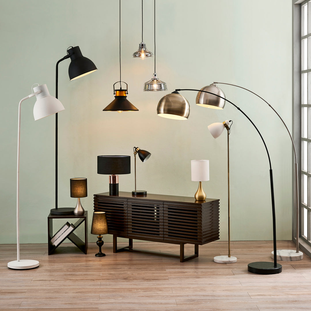 Teamson Home's floor and table lamp options, with two Sarah table lamps - one in silver with a black shade on the left, and one in brass with a cream shade on the right.