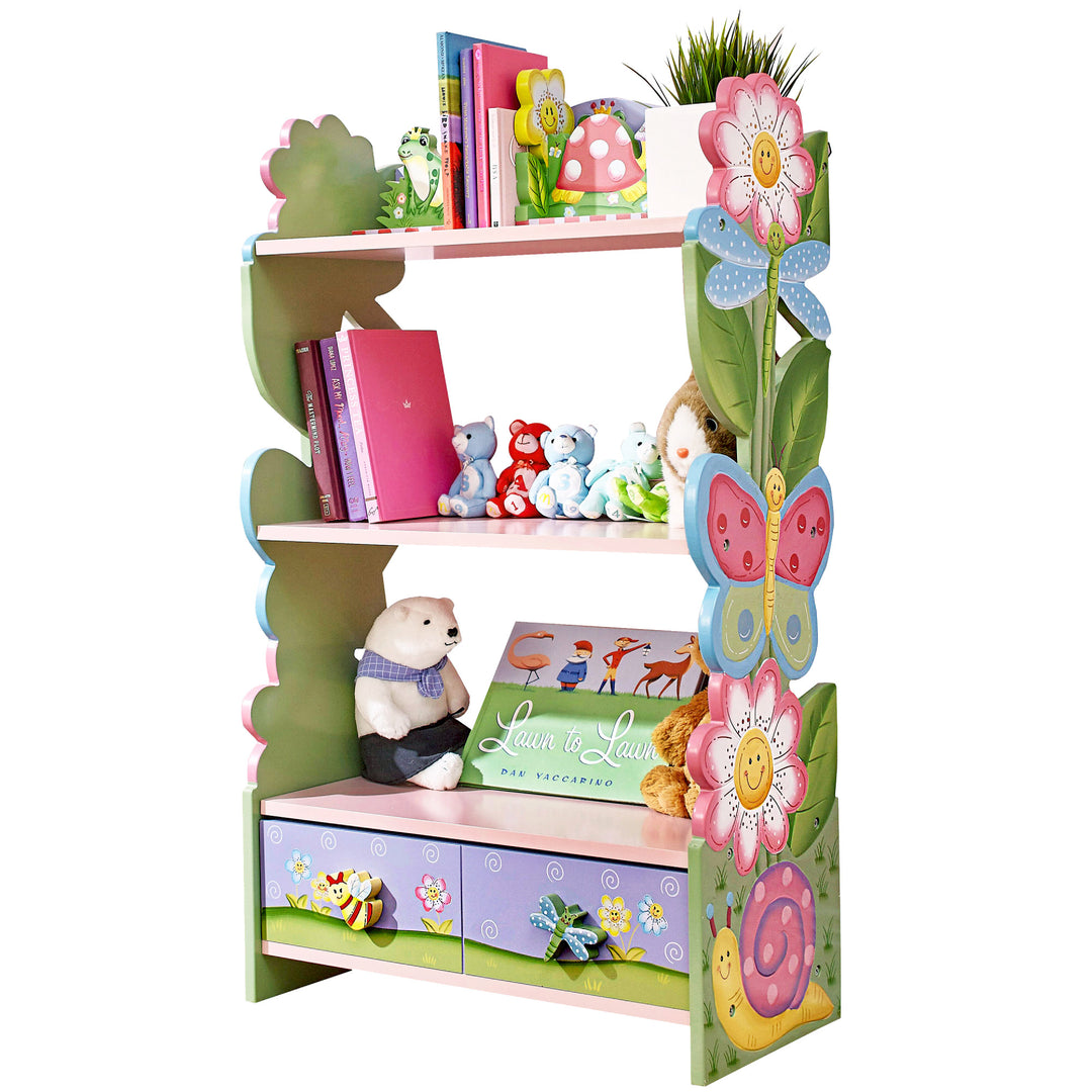 A Fantasy Fields Magic Garden Wooden Bookshelf with Storage Drawers, Multicolor for kids with flowers and teddy bears.