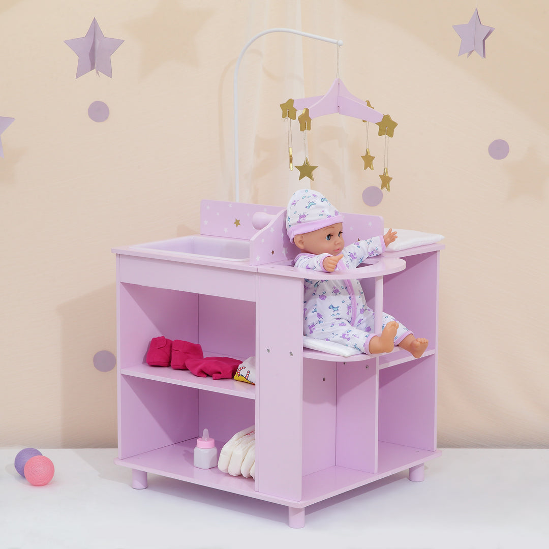 A baby doll changing station in purple with white and gold stars with a baby doll sitting in the high chair and items on the strorage shelves.